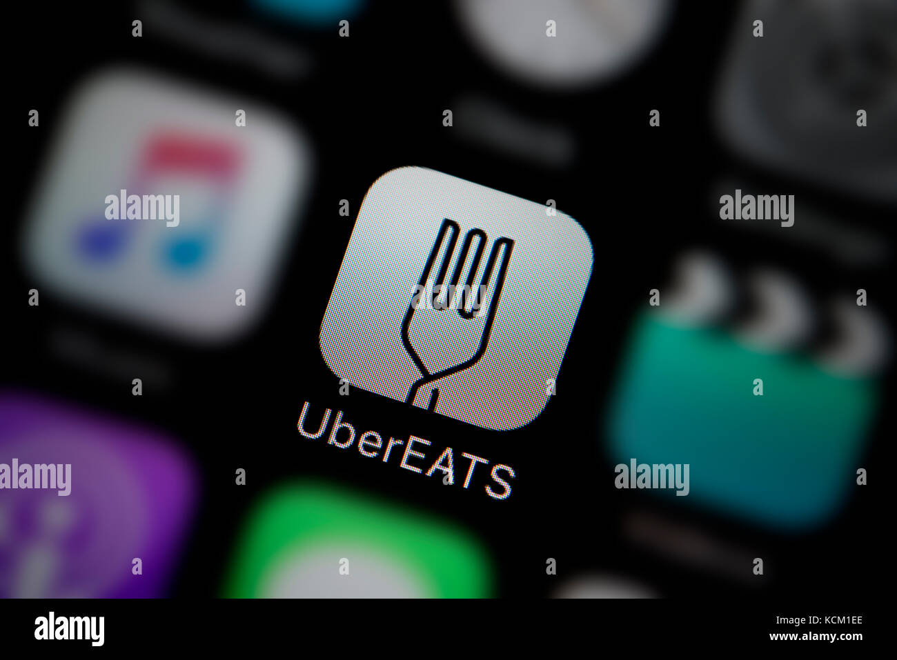A close-up shot of the company logo representing the UberEATS app icon, as seen on the screen of a smart phone (Editorial use only) Stock Photo