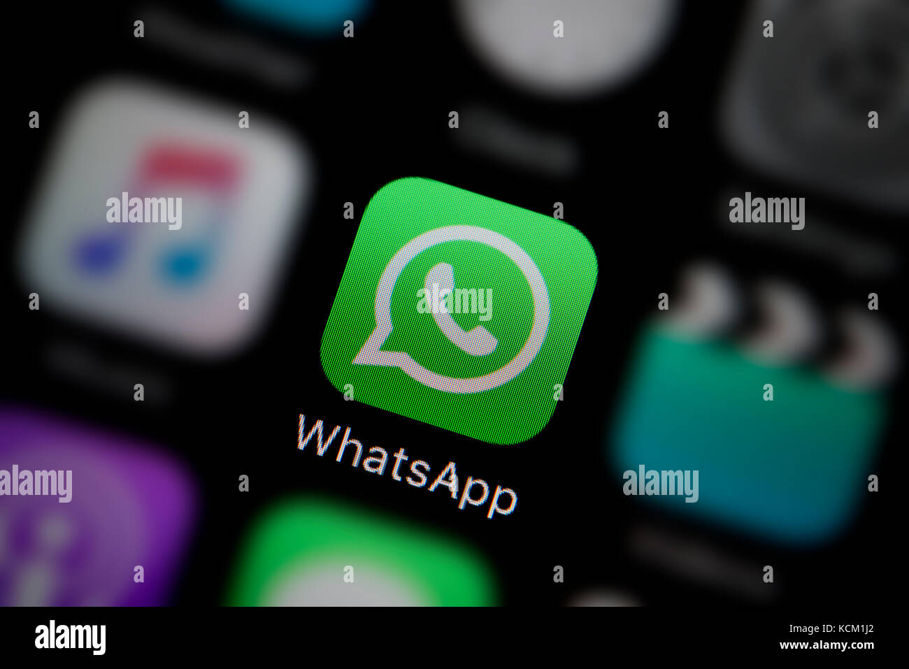 A close-up shot of the company logo representing the WhatsApp app icon, as seen on the screen of a smart phone (Editorial use only) Stock Photo