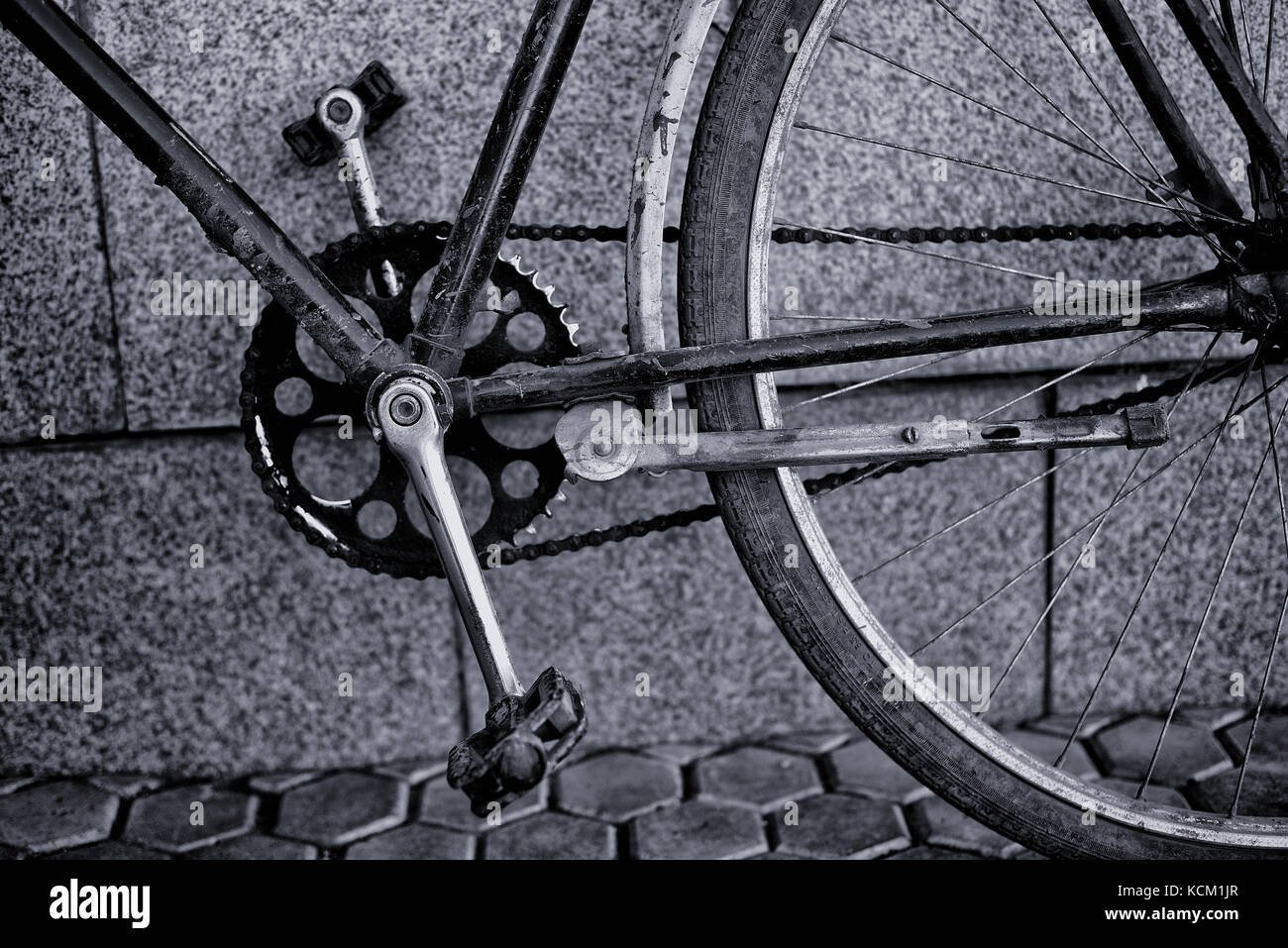 Closeup of an old blue vintage retro bicycle with pedals and chain cog ...