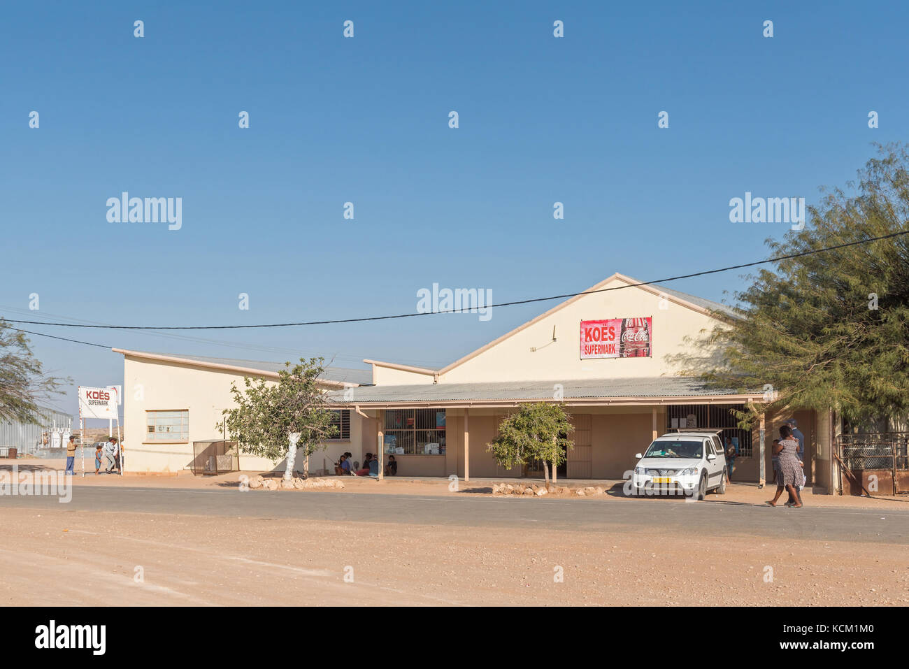 KOES - JULY 5, 2017: A street scene with a supermarket and people in Koes, a small town in the Karas Region in Namibia Stock Photo