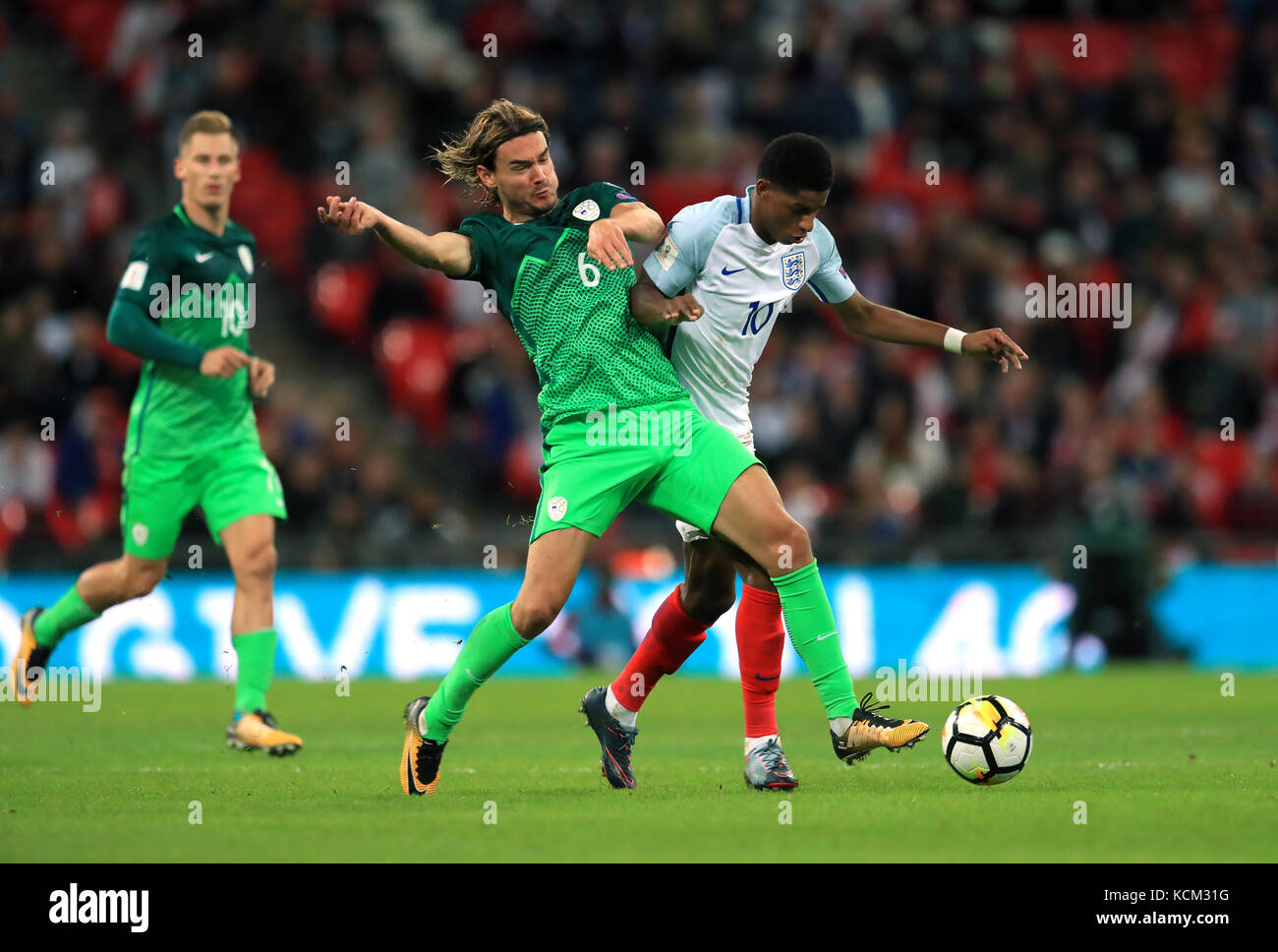 Slovenia's Rene Krhin (left) and England's Marcus Rashford (right) battle for the ball during the 2018 FIFA World Cup Qualifying, Group F match at Wembley Stadium, London. Stock Photo