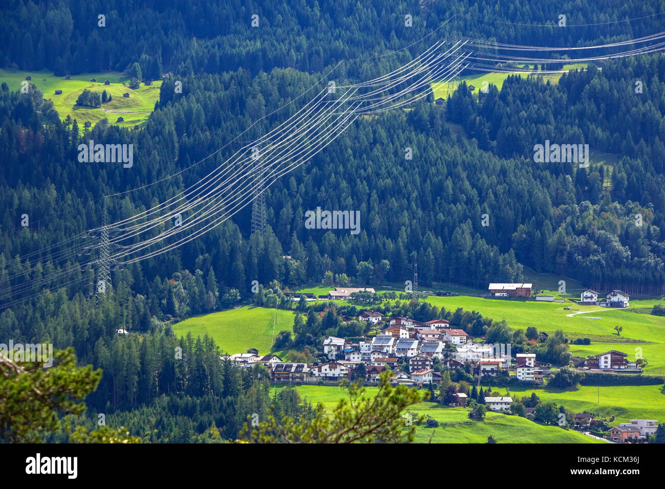 Electric transmission cables and village, near Imst, Austria, Stock Photo