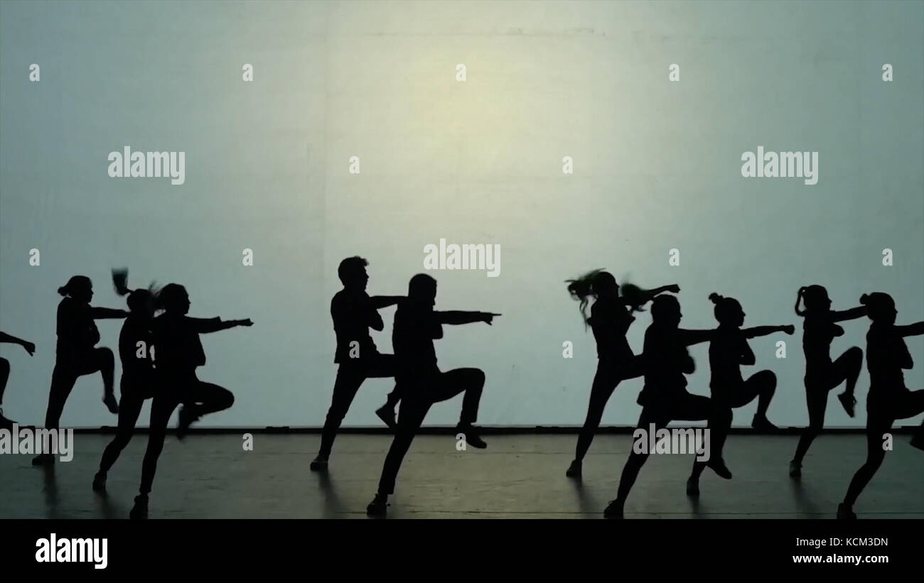 Dance of shadows. Dancers dancing on the stage. Dancers silhouettes