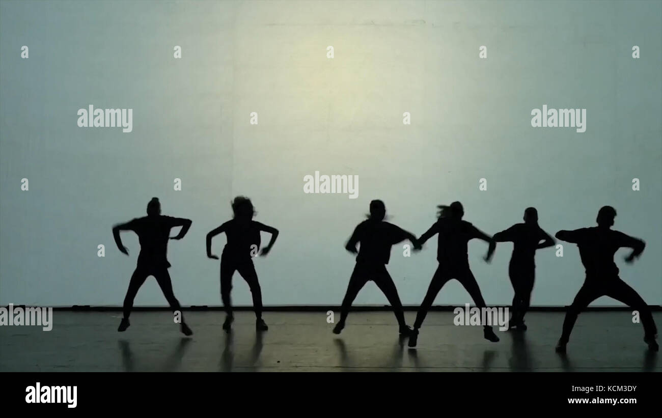 Dance of shadows. Dancers dancing on the stage. Dancers silhouettes ...