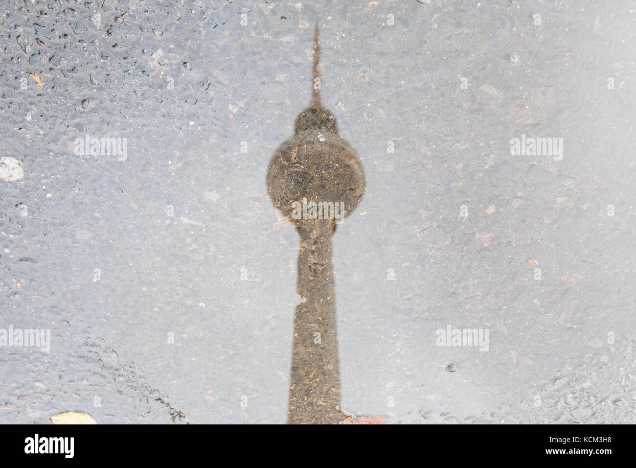 tv tower Berlin water reflection in puddle - Stock Photo