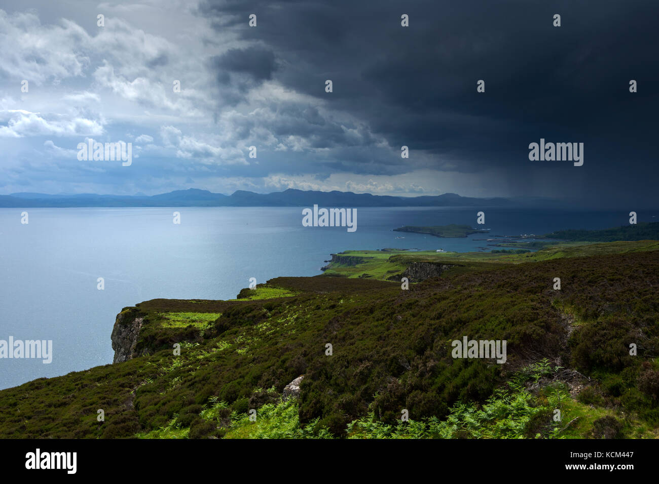 The Scottish mainland from the eastern edge of the Beinn Bhuidhe plateau with a storm approaching, on the Isle of Eigg, Scotland, UK Stock Photo
