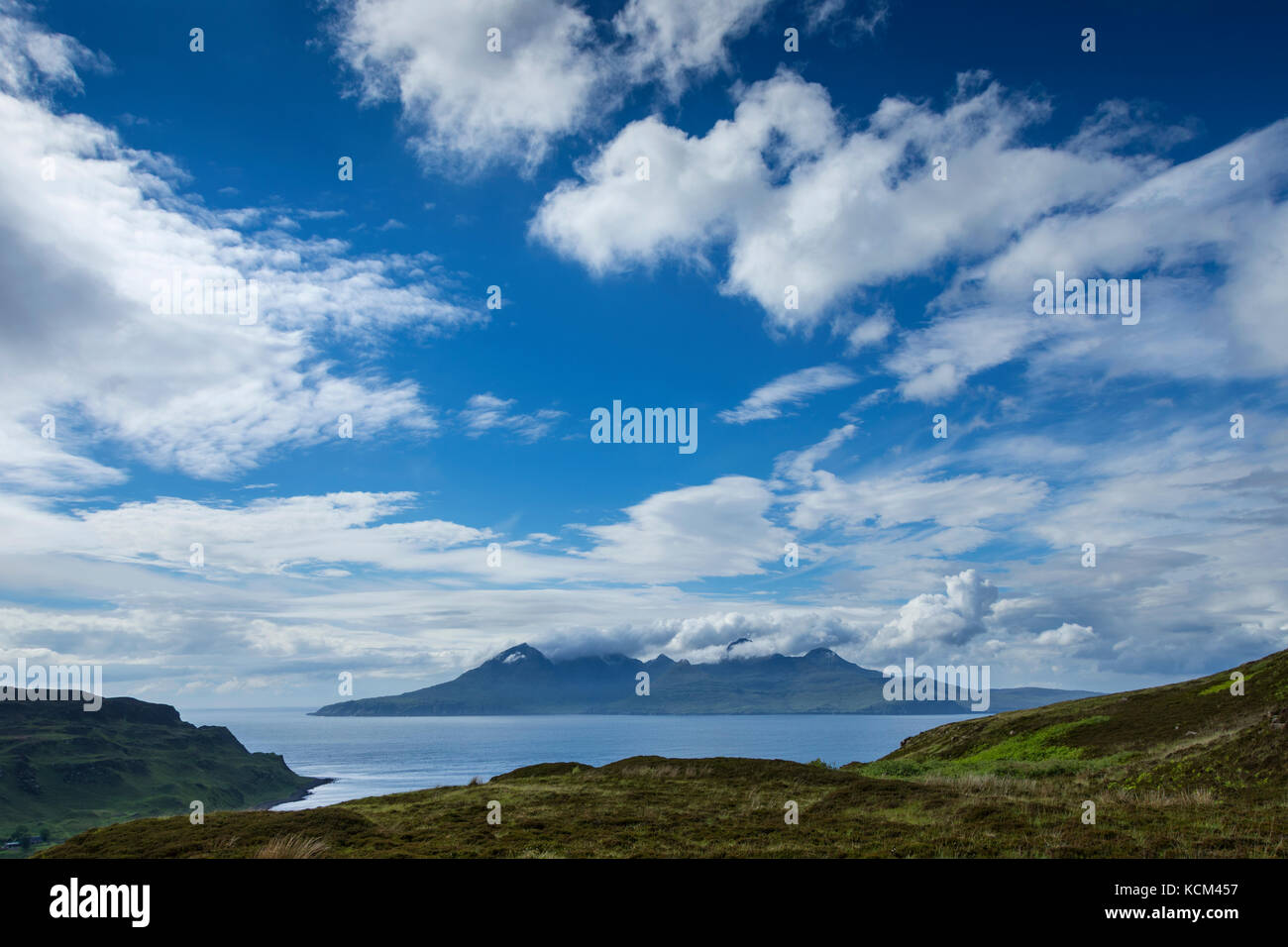 The Isle of Rum over the Bay of Laig on the Isle of Eigg, Scotland, UK Stock Photo