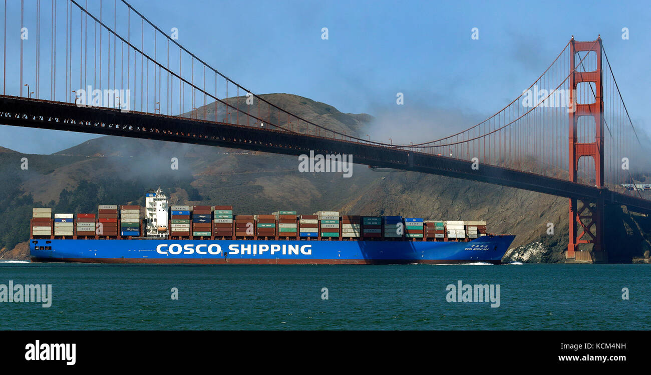 Cosco shipping container ship Bohai Sea steams under the Golden Gate Bridge in San Francisco. Stock Photo