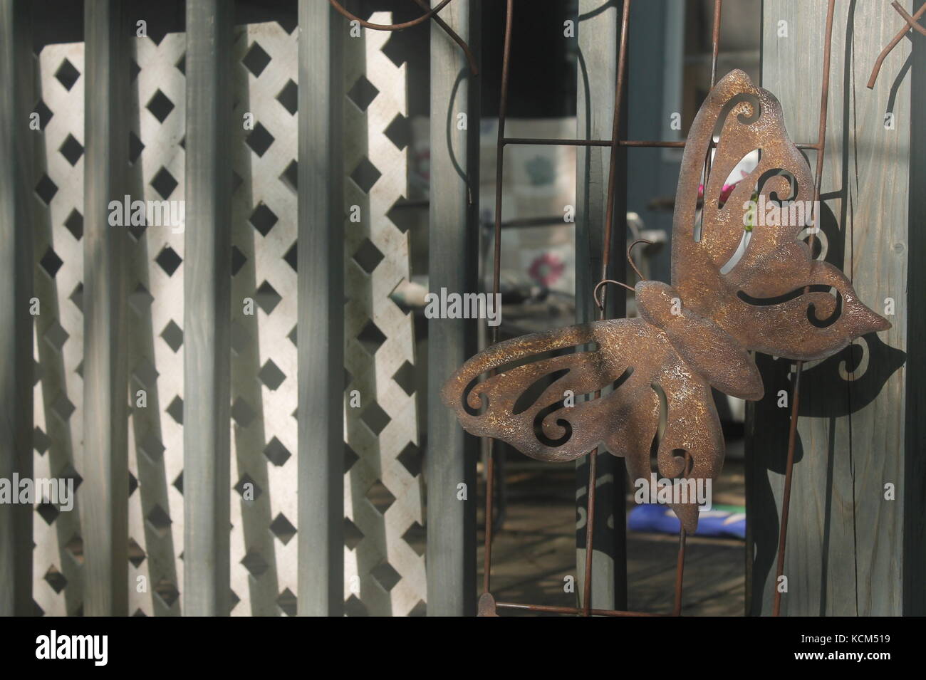 A porch railing with an attached steel butterfly Stock Photo - Alamy