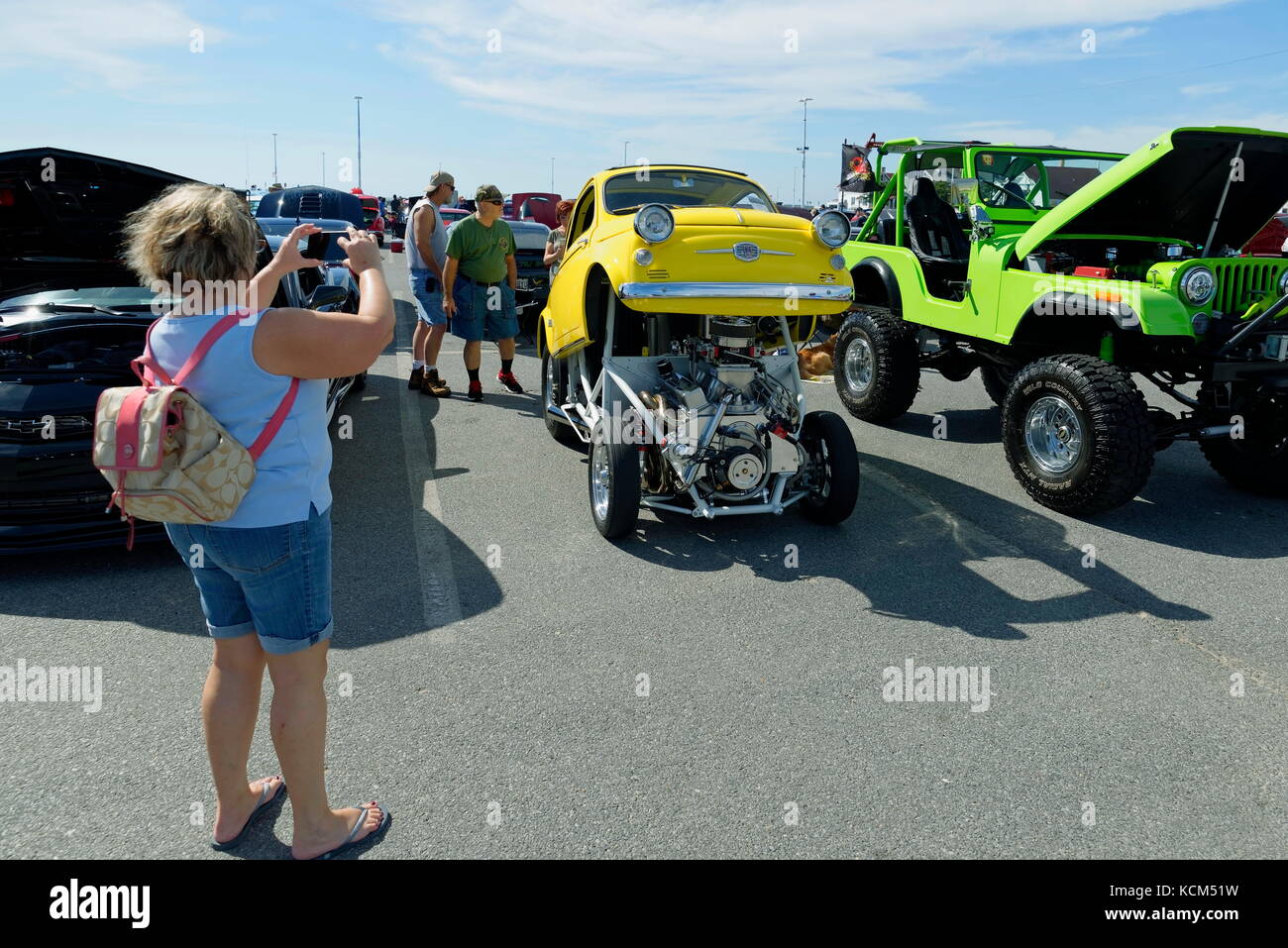 Woman spectator photographs a mini car hot  rod at the annual  Endless Summer Cruisin, Ocean City, Maryland, USA. Stock Photo
