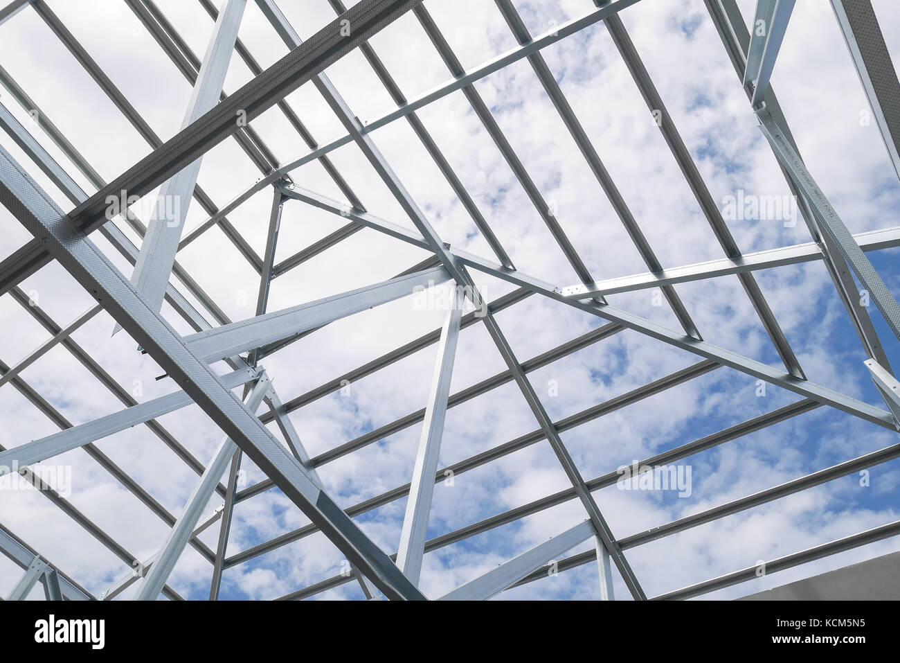 Structure Of Steel Roof Frame With Blue Sky And Clouds At