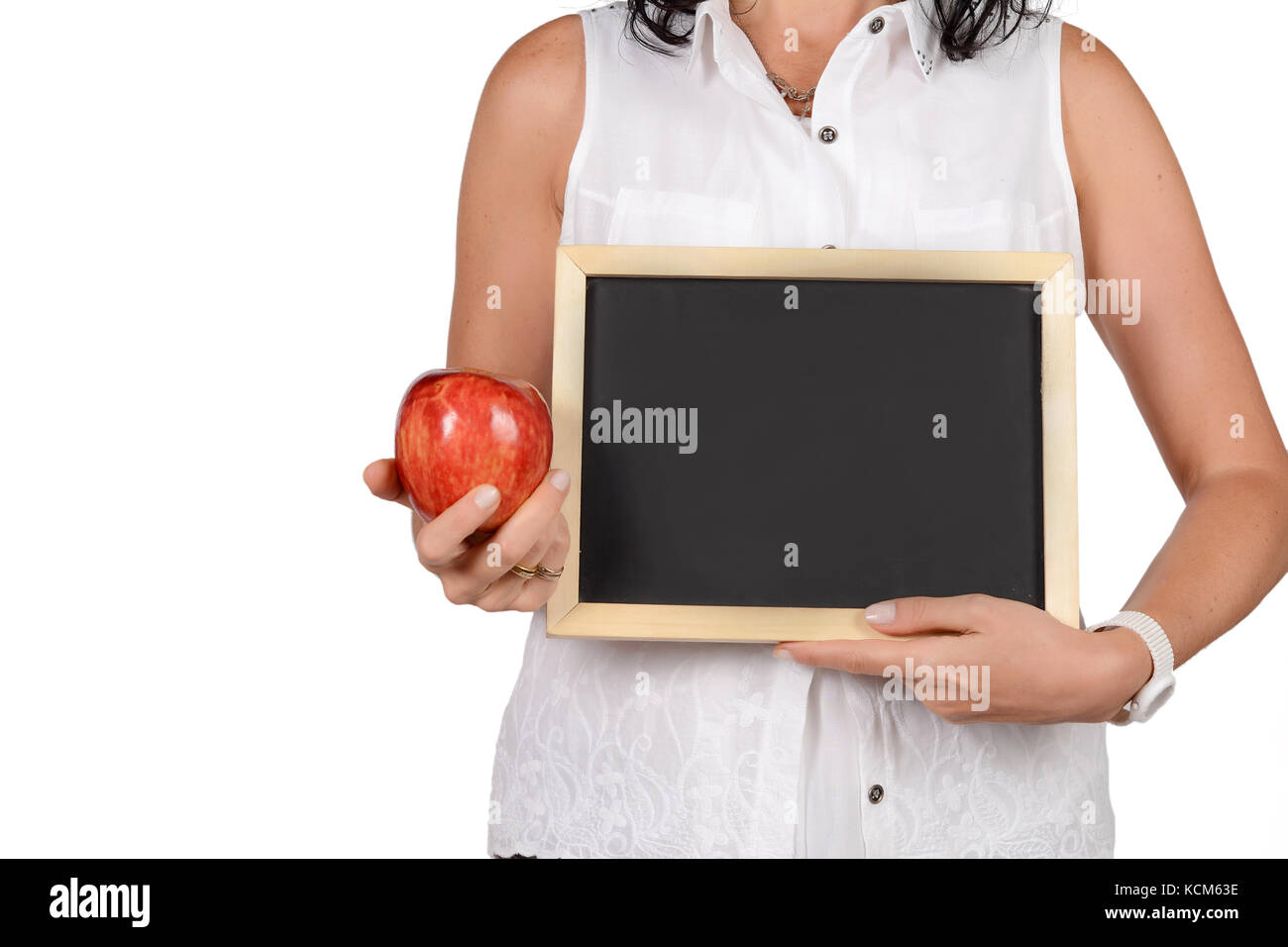 Portrait of beautiful school teacher holding an empty chalkboard. Education concept. Isolated white background. Stock Photo