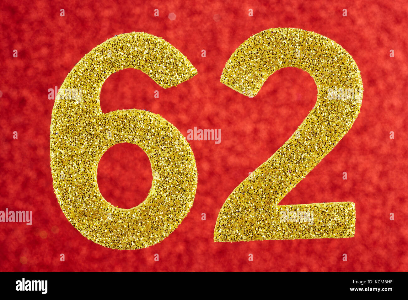Number sixty-two golden color over a red background. Anniversary. Horizontal Stock Photo