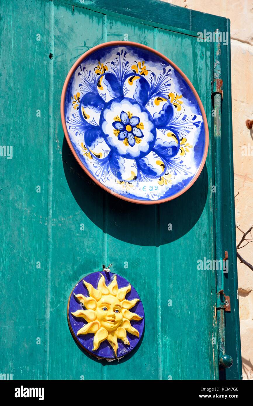 Traditional Maltese plates on a green door in the old town, Mdina