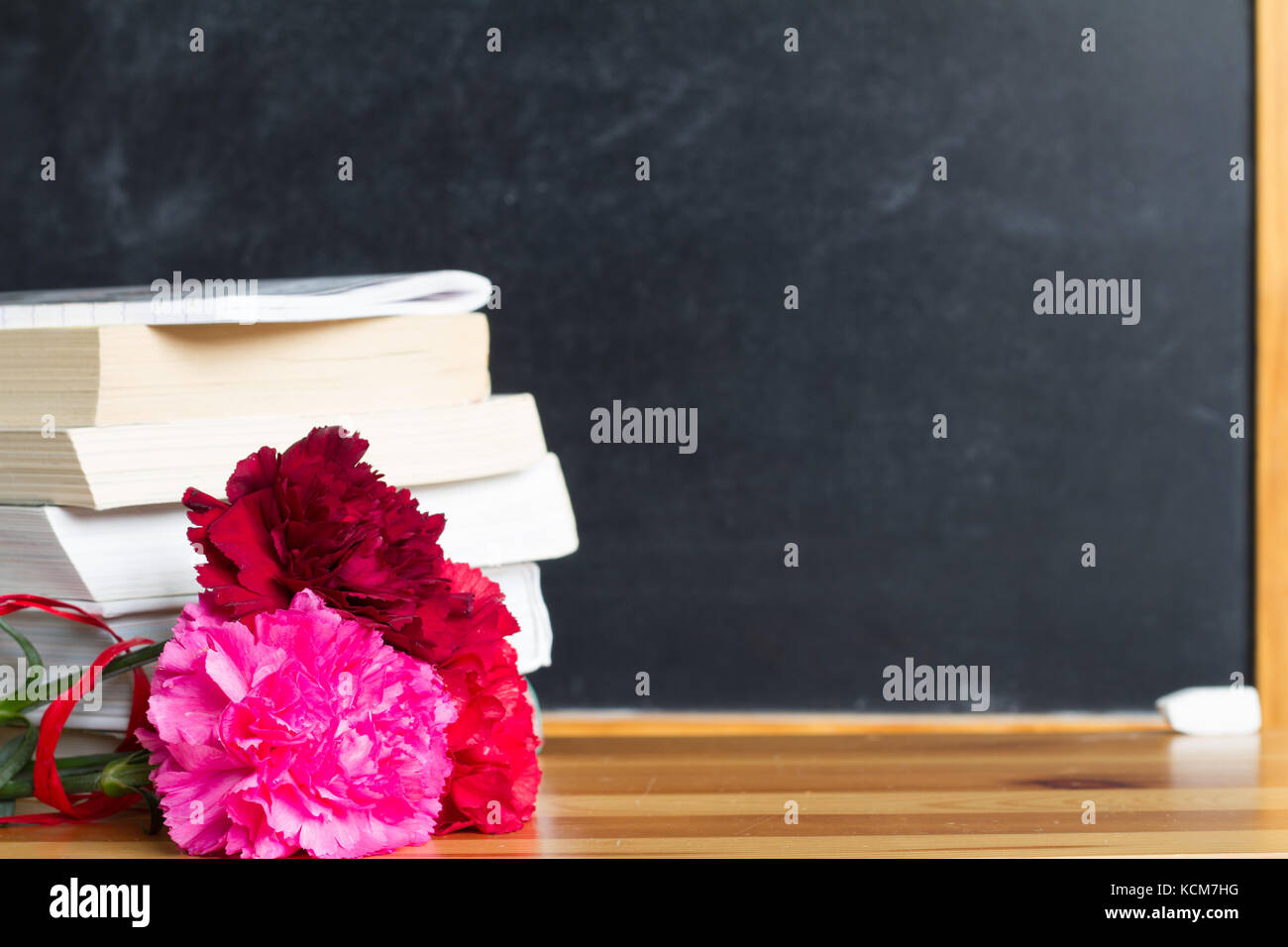 Flowers and blackboard in classroom teacher day background concept Stock  Photo - Alamy