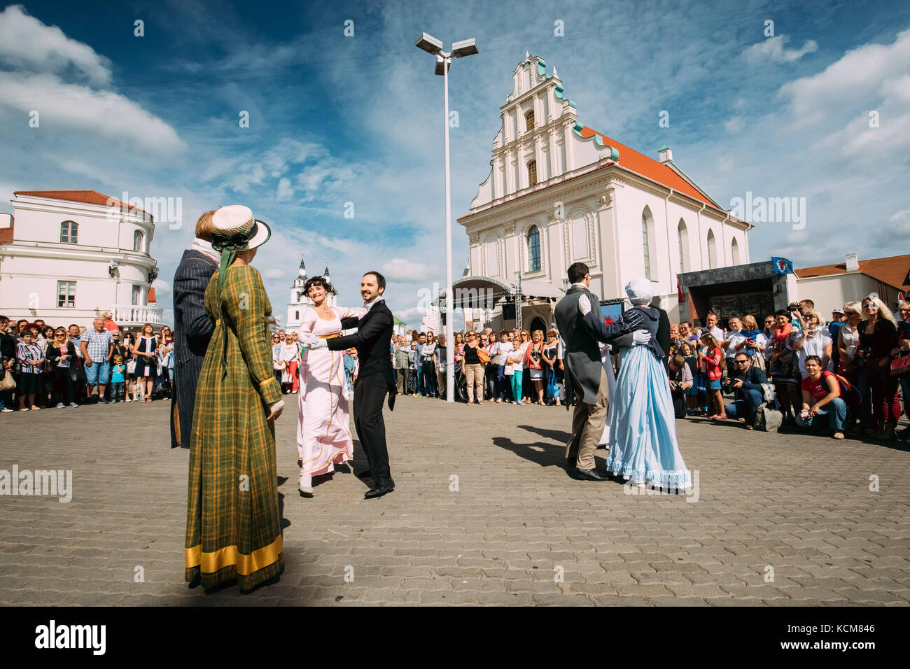 Minsk, Belarus - September 3, 2016: Couple of young people dressed in clothes of the 19th century dancing Polonaise at the celebration of the Day of M Stock Photo