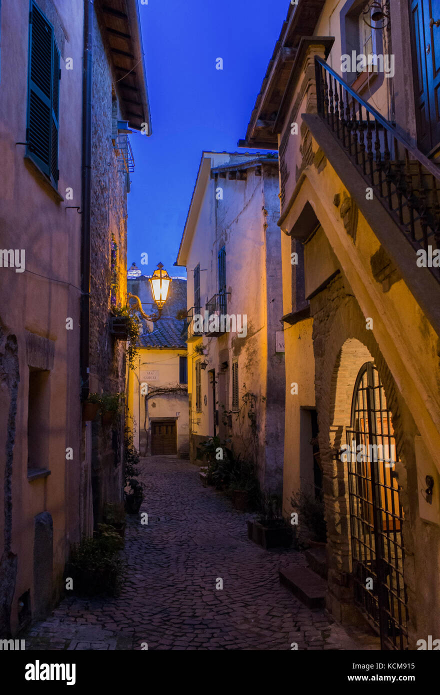 A typical street of little town of Trevignano Romano, on Bracciano lake, near Rome, Italy at the dusk, nicely illuminated by lamps Stock Photo