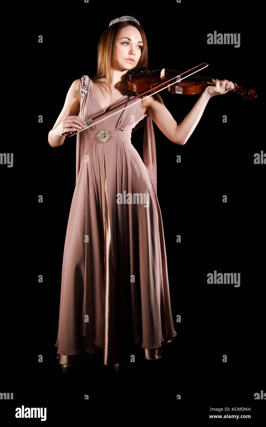 Pretty young woman playing a violin over black background Stock Photo ...