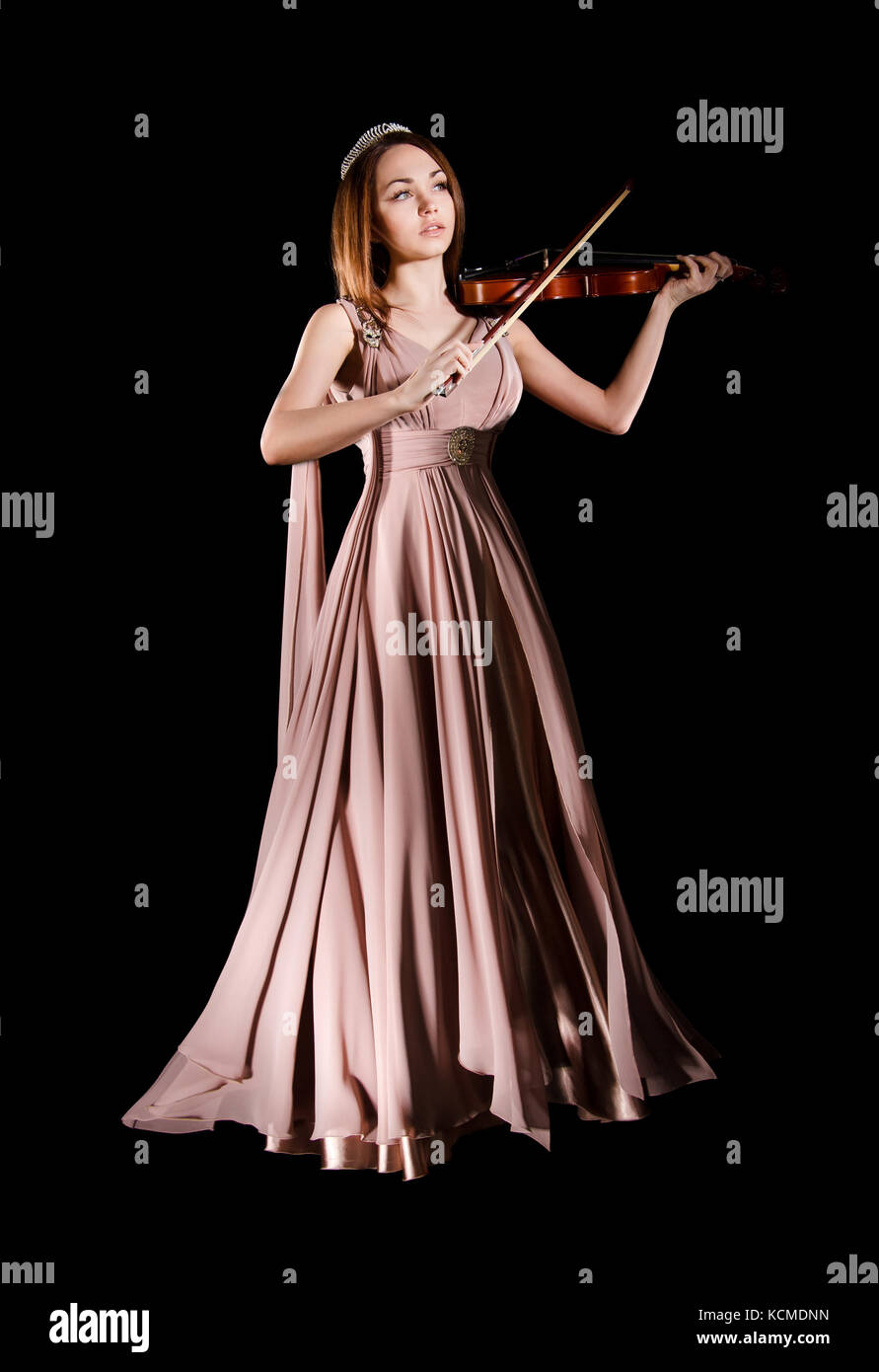 Pretty young woman playing a violin over black background Stock Photo ...
