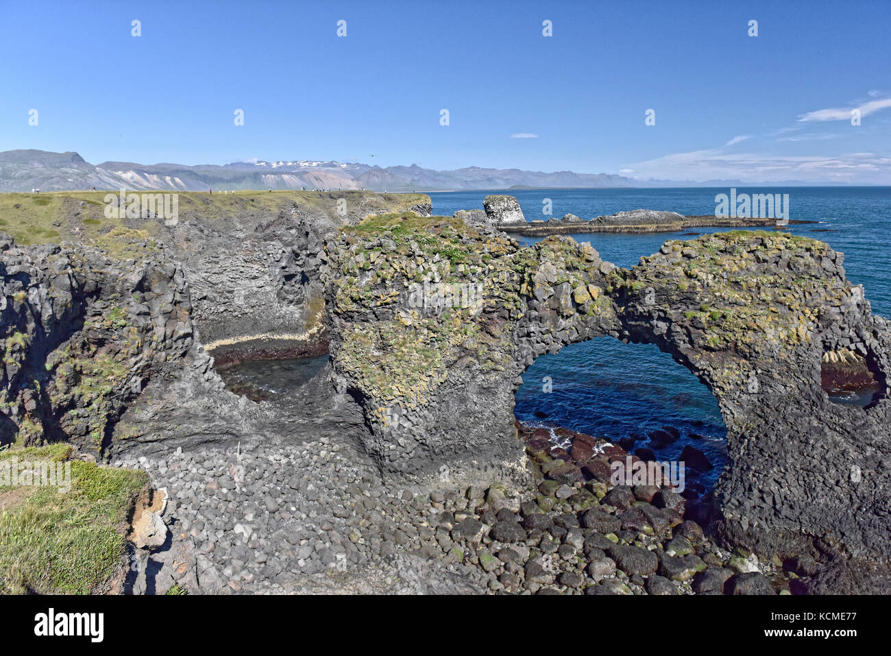 Shoreline and cliffs of basalt rock at Arnarstapi nature reserve seen ...