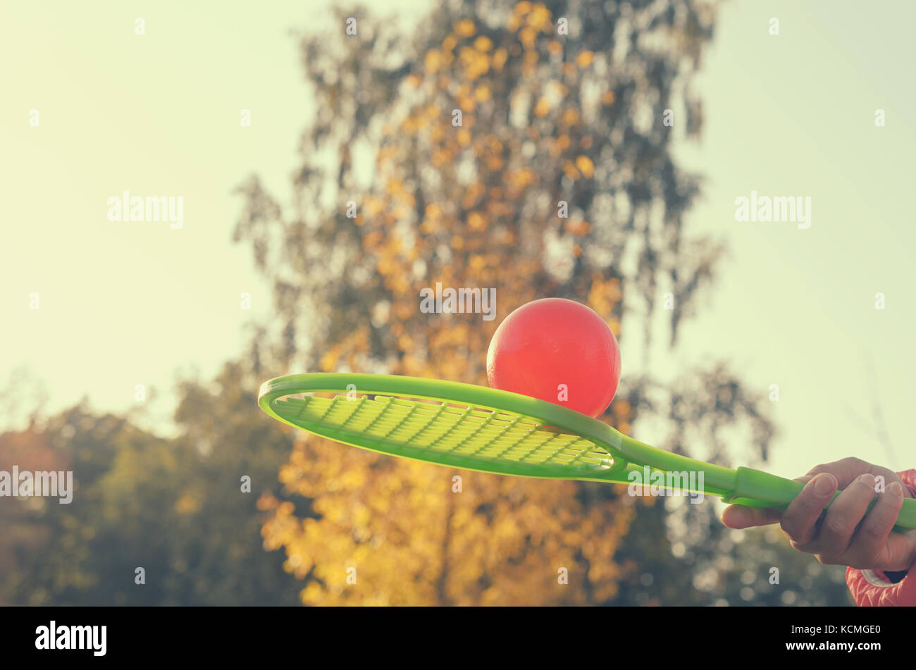 A tennis racket in his hand catches the ball in motion Stock Photo - Alamy