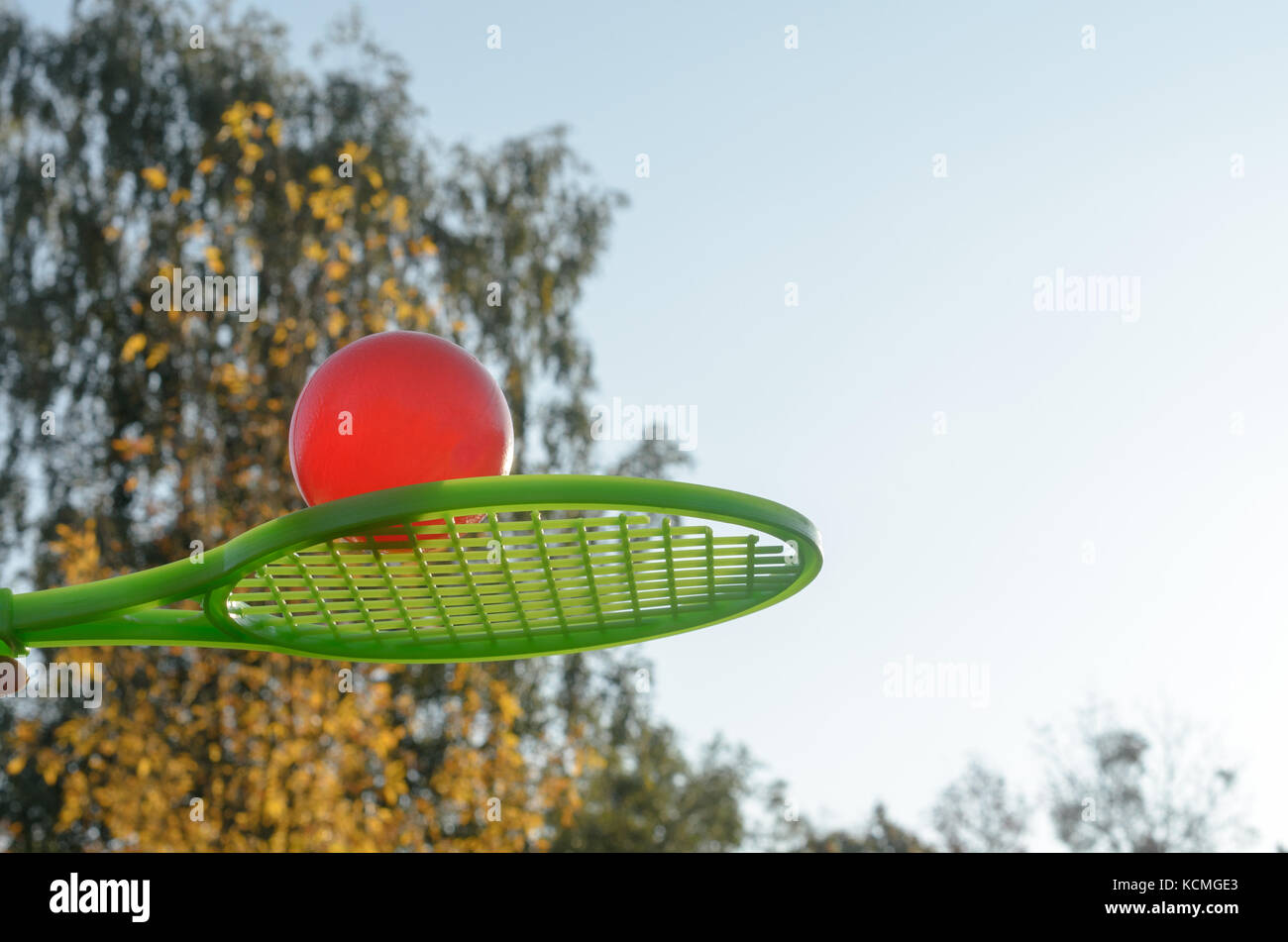 A tennis racket in his hand catches the ball in motion Stock Photo - Alamy