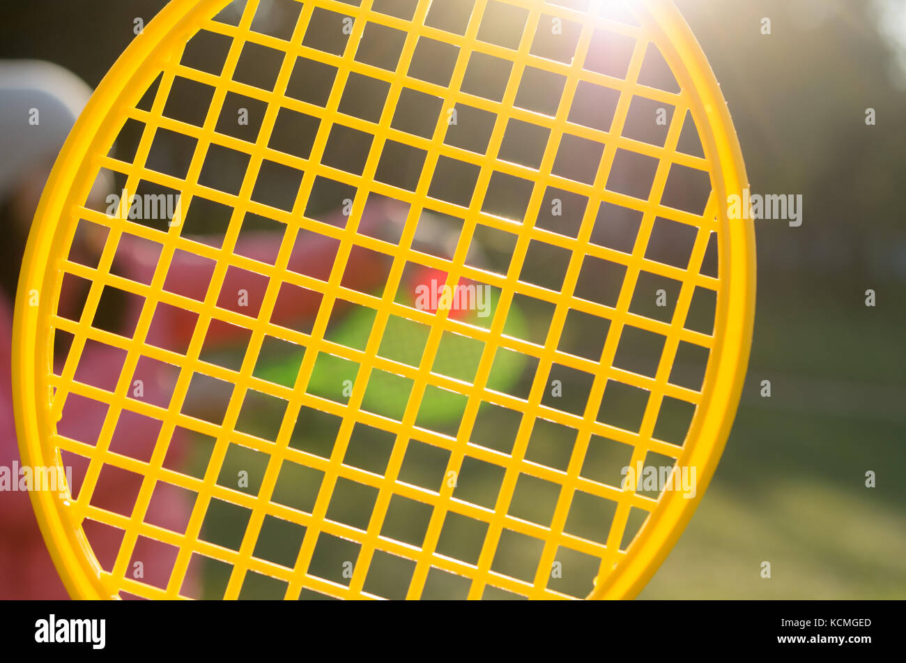 A tennis racket in his hand catches the ball in motion Stock Photo - Alamy