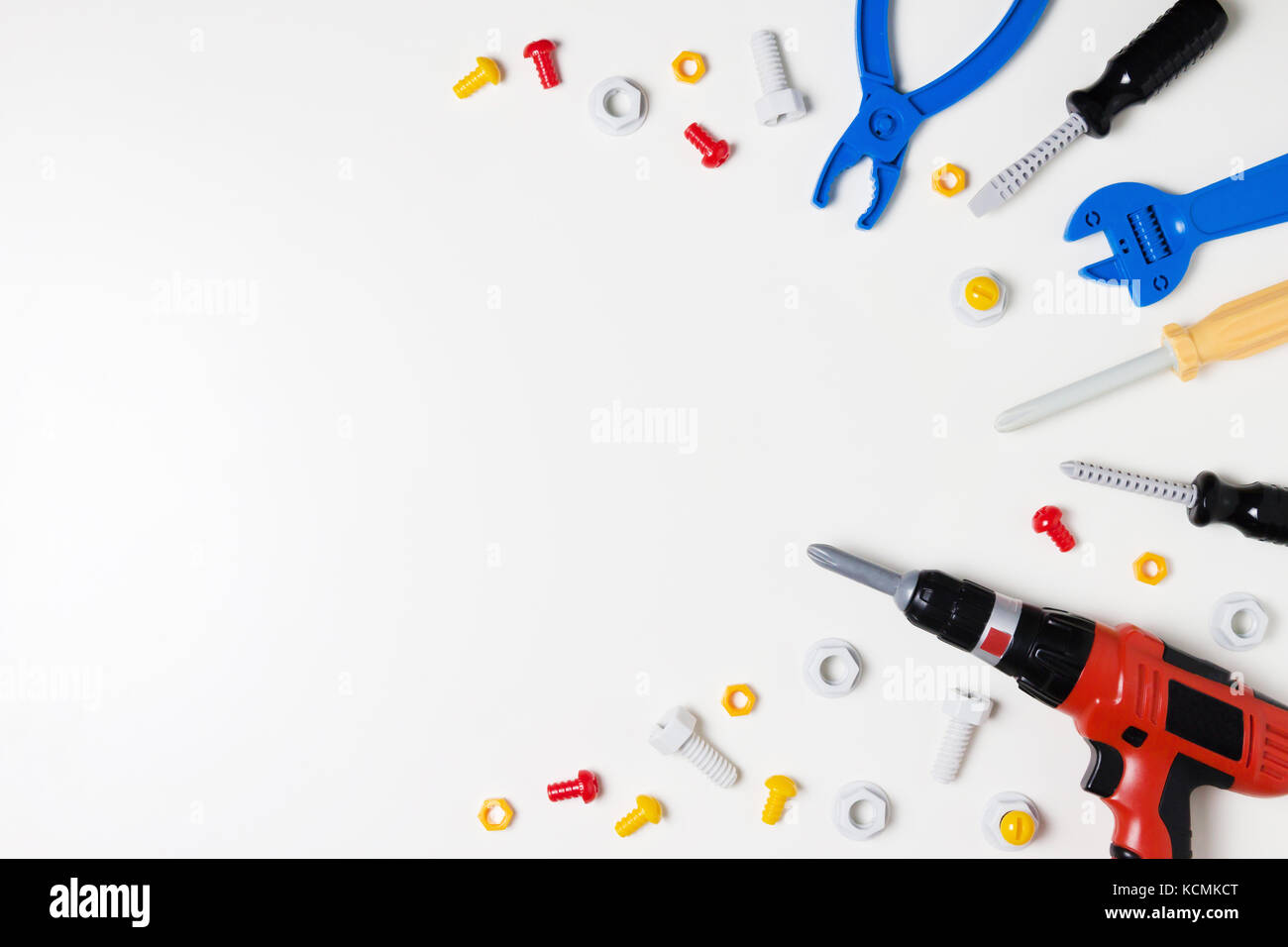 Toys construction tools border frame on white background. Top view
