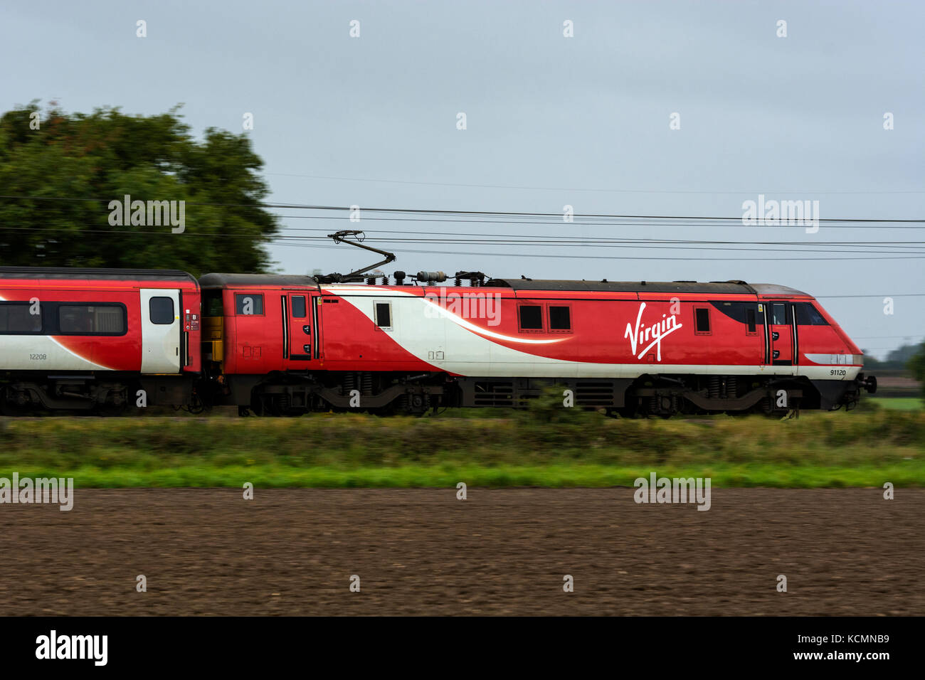 Virgin Trains electric train at speed on the East Coast Main Line, Nottinghamshire, England, UK Stock Photo