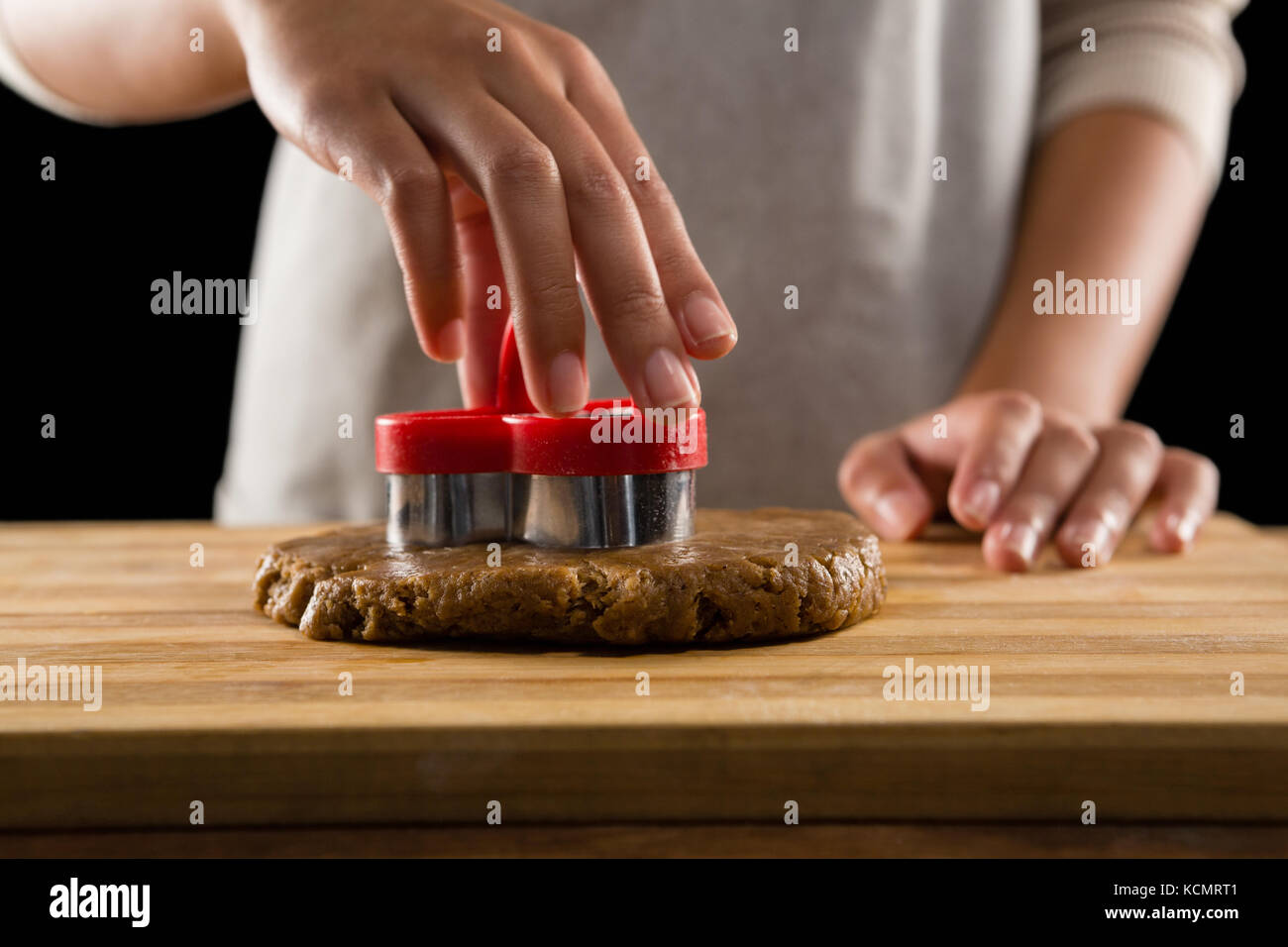 Mid-section of man molding gingerbread dough on wooden board Stock Photo