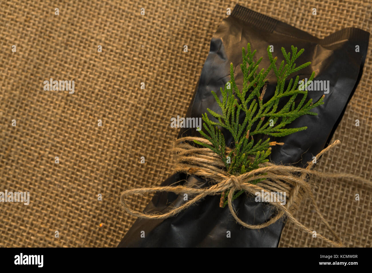 Close up of packet and pine twig tied with rope on burlap Stock Photo ...