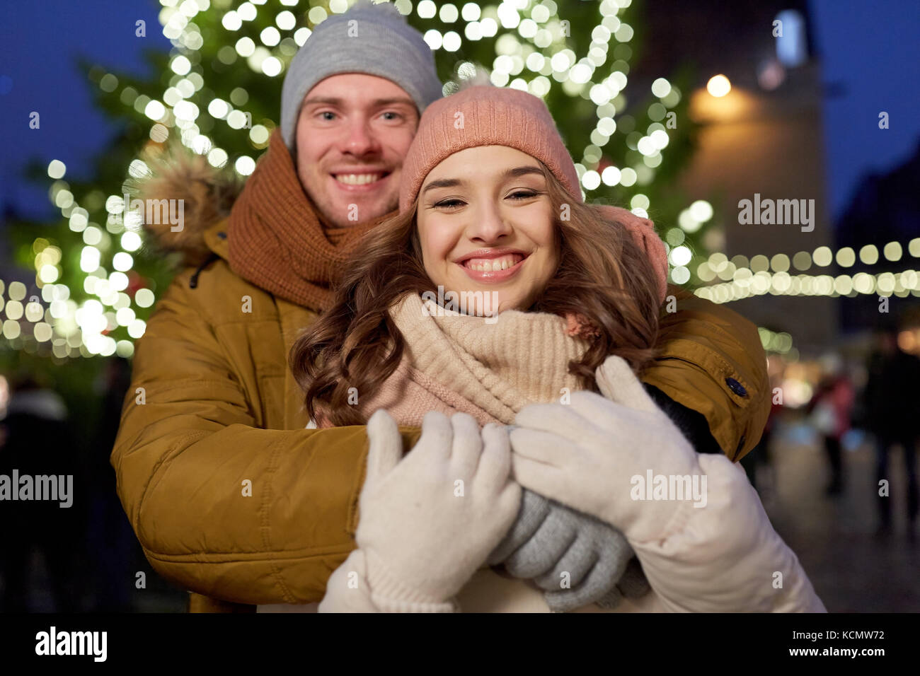 happy couple hugging at christmas tree Stock Photo