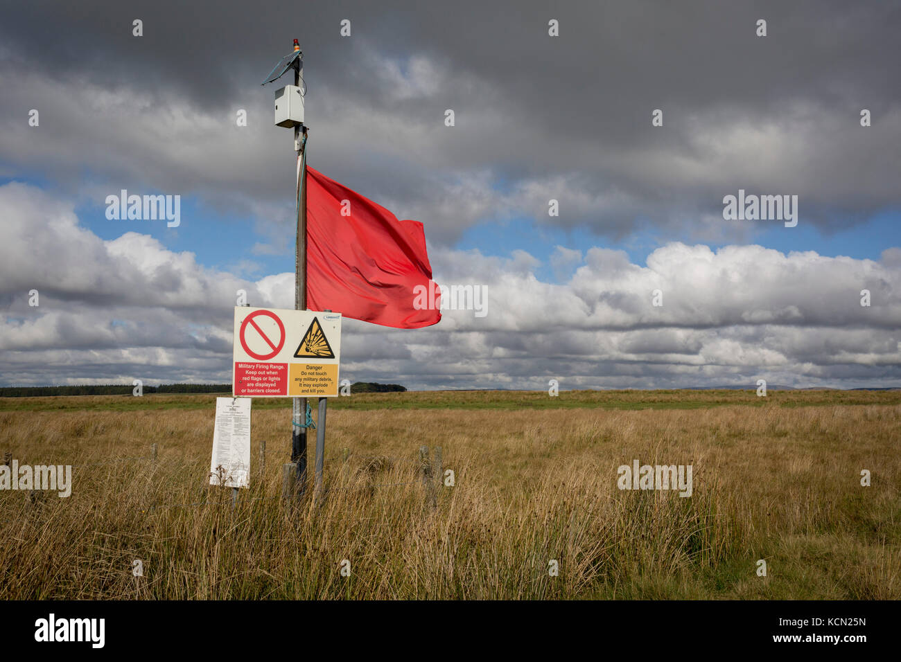 A red warning flag flies on the perimeter during military live firing at Otterburn Ranges, on 28th September 2017, in Otterburn, Northumberland, England. Twenty-three per cent of Northumberland National Park is owned by the Ministry of Defence and used as a military training area though they encourage as much access to the area as possible. Sometimes areas are cordoned off from the public for military exercises. Visitors are welcome outside of live firing times if no red flags are displayed. When military exercises are happening, red flags around the boundaries indicate restricted access. Visi Stock Photo