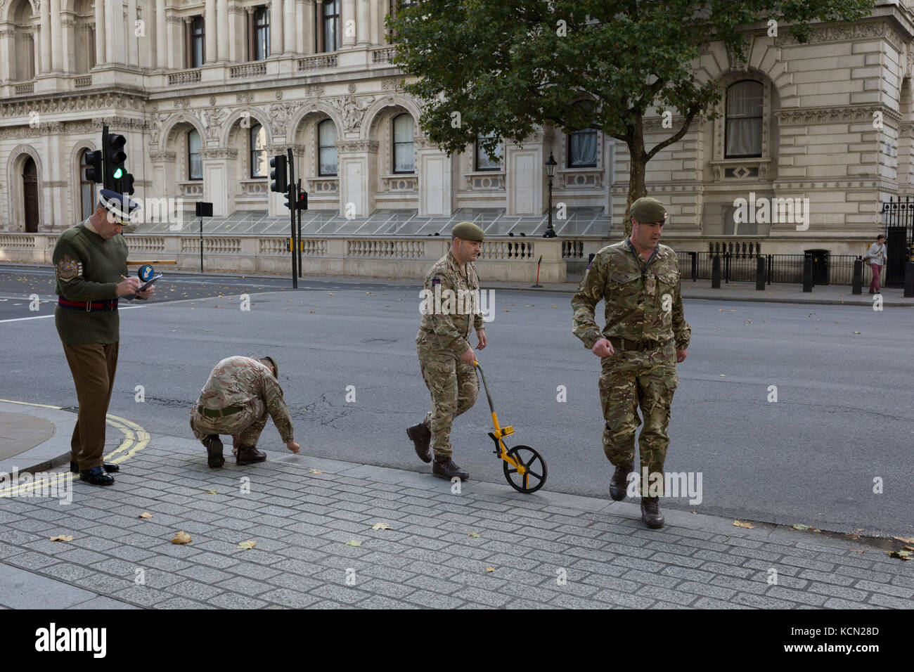 According to protocol, members of the Coldstream Guards, led by 'H. M. Ceremonial Warrant Officer WO1 (GSM) Andrew 'Vern' Stokes, mark in chalk the route along Whitehall for a future ceremony, on 5th October, 2017, in London, England. Stock Photo