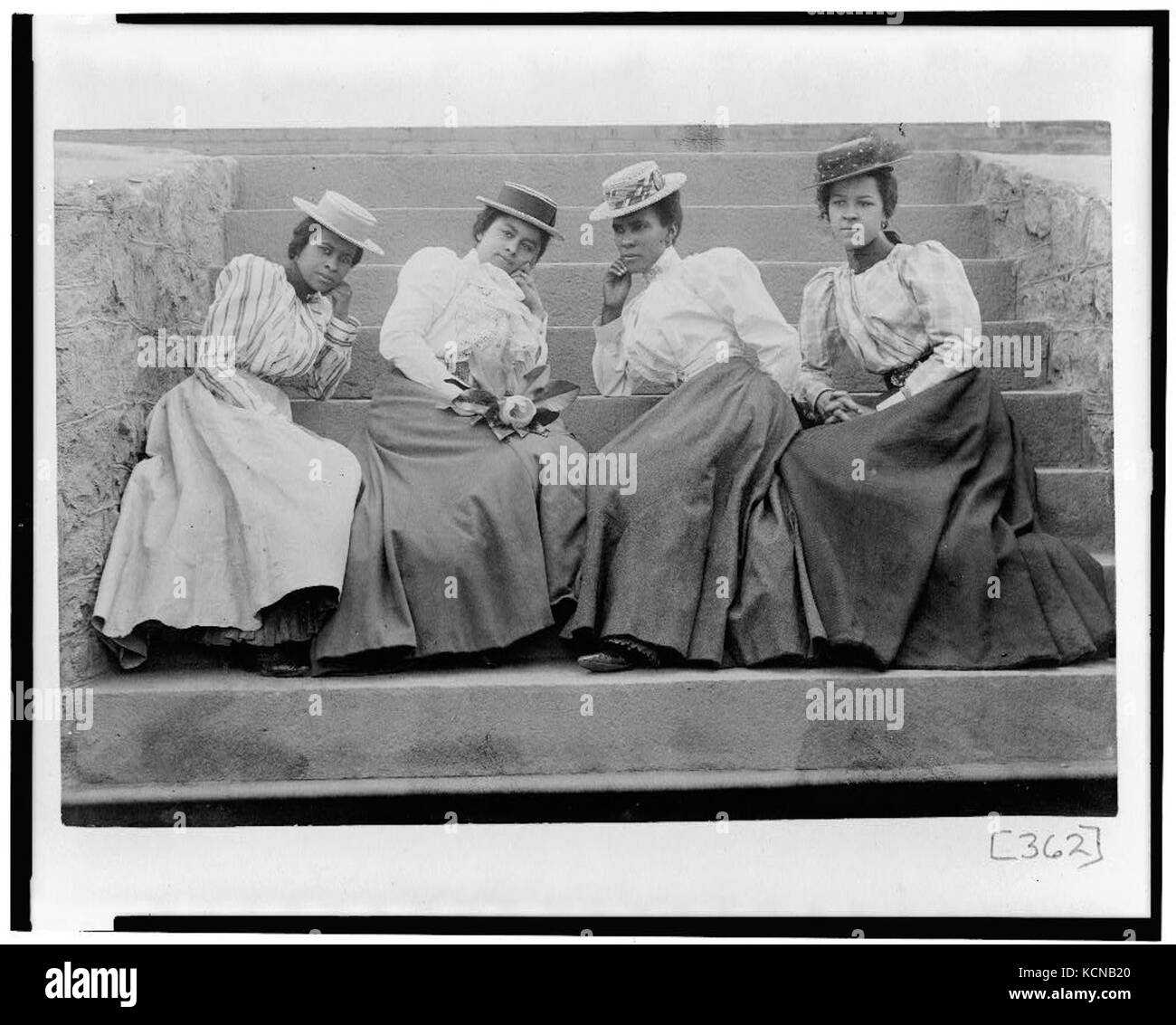 Four African American women seated on steps of building at Atlanta ...