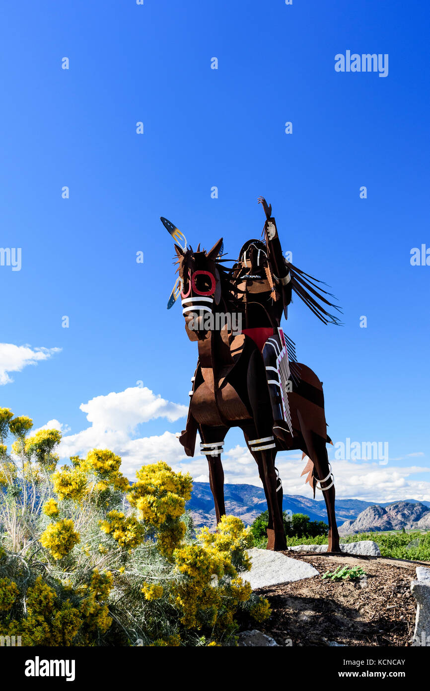 A statue of a native Indian with headdress riding a horse in Osoyoos, British Columbia, Canada Stock Photo