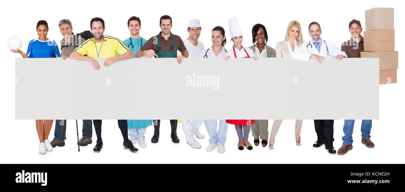Group of diverse professionals presenting empty banner. Isolated on white Stock Photo