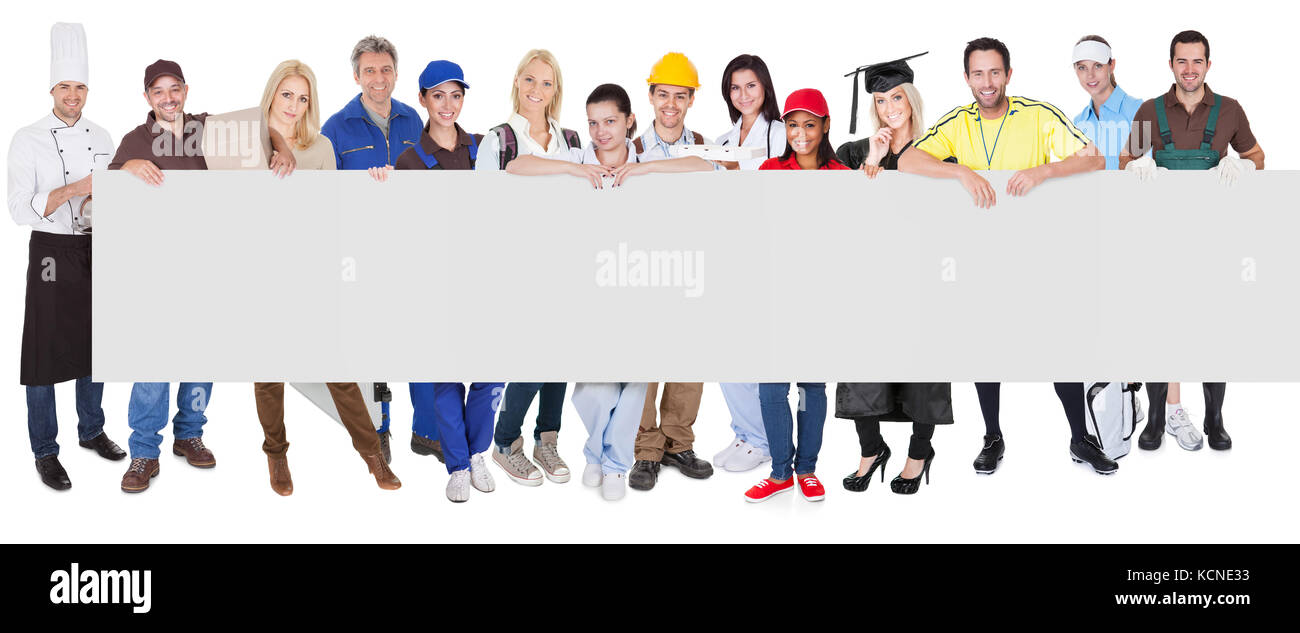 Group of diverse professionals presenting empty banner. Isolated on white Stock Photo
