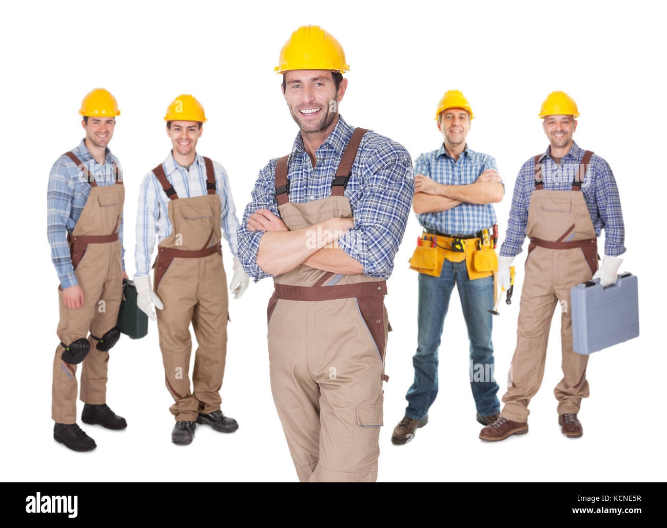 Portrait of happy construction worker standing in front of his team ...