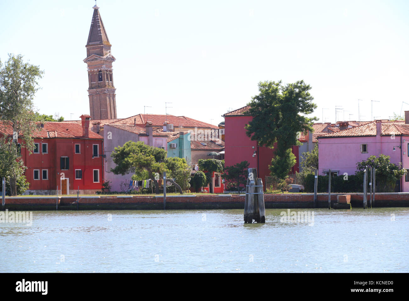 Burano is a small island near Venice in Italy. The bell tower is pending and the houses are very colorful Stock Photo