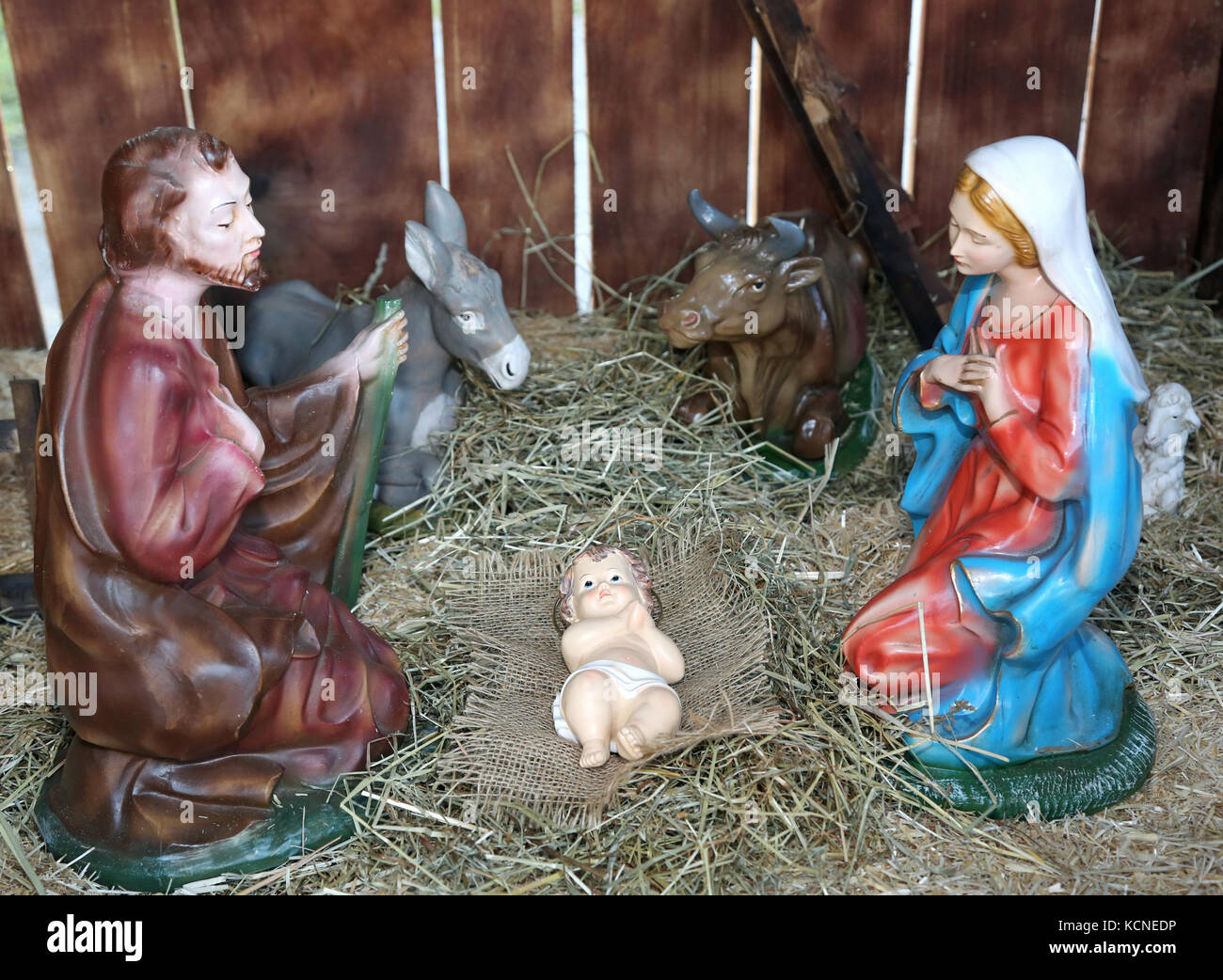 classic nativity scene with statues of the Holy family praying in the