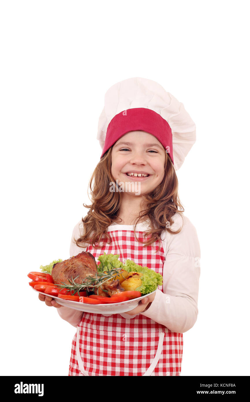 happy little girl cook with turkey drumstick and salad on dish Stock Photo