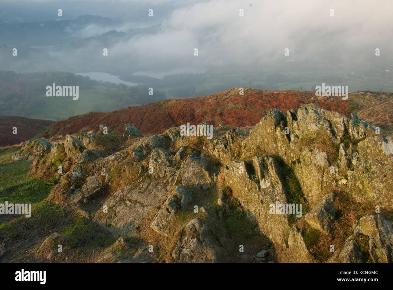 Early morning light over Loughrigg, looking down to Elterwater, low clouds, Lake District National Park, Uk Stock Photo