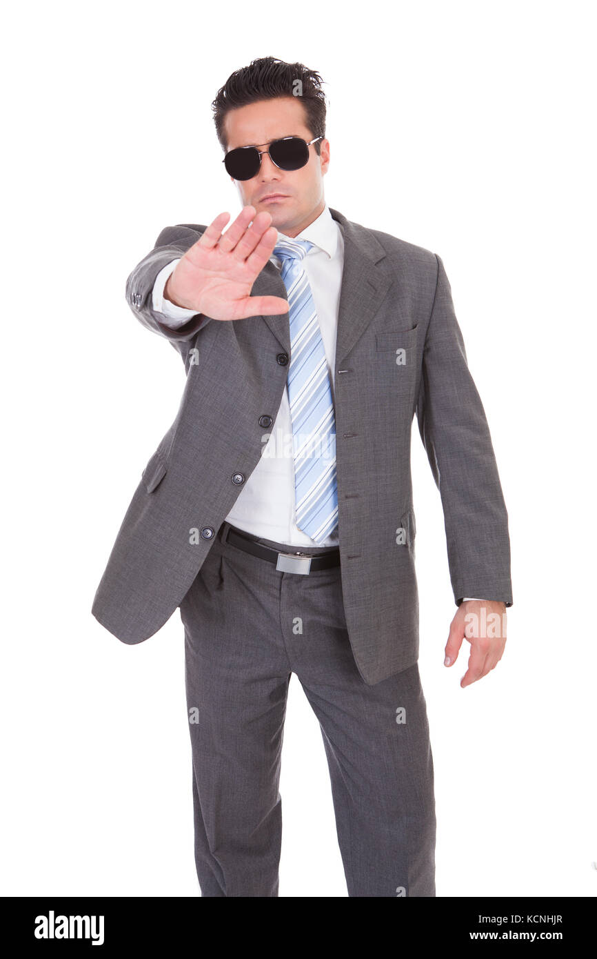 Portrait Of Young Businessman Wearing Sunglasses Gesturing Stop Sign Stock Photo