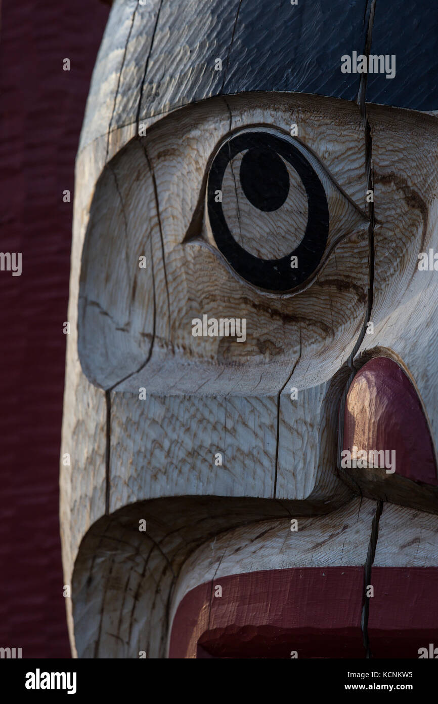 A totem pole's tight cropping creates a strong design in wood, Comox. Stock Photo