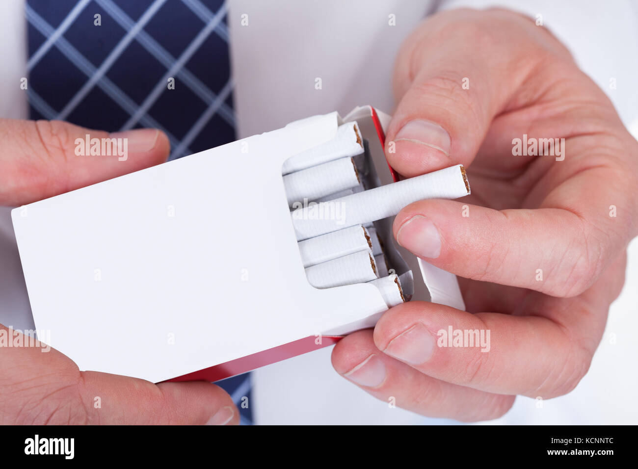 Close-up Of Man Hand Taking Cigarette  From Packet Stock Photo