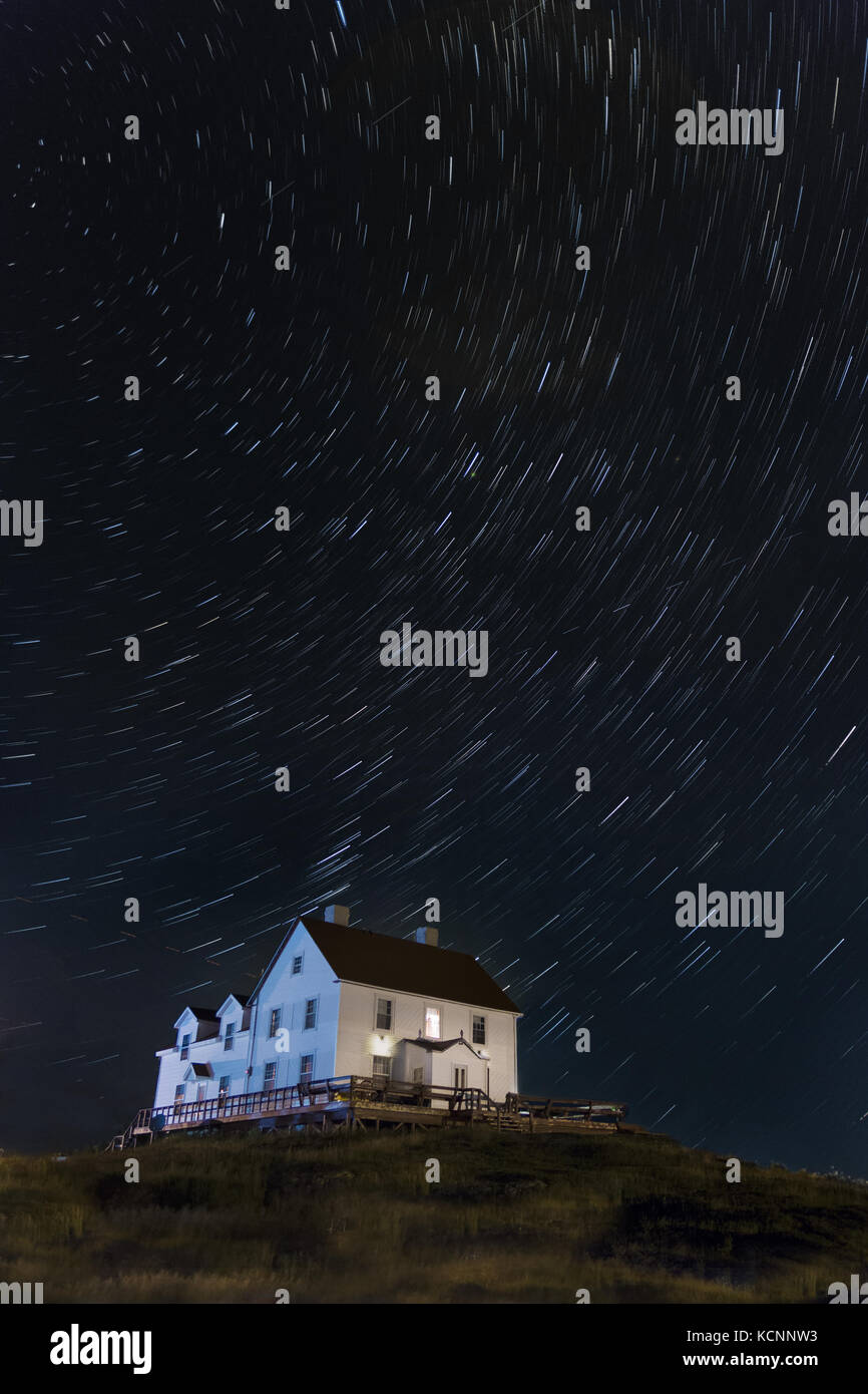 Night sky,  star Trails over an old fish Merchants residence, Cange Islands, Newfoundland & Labrador Stock Photo