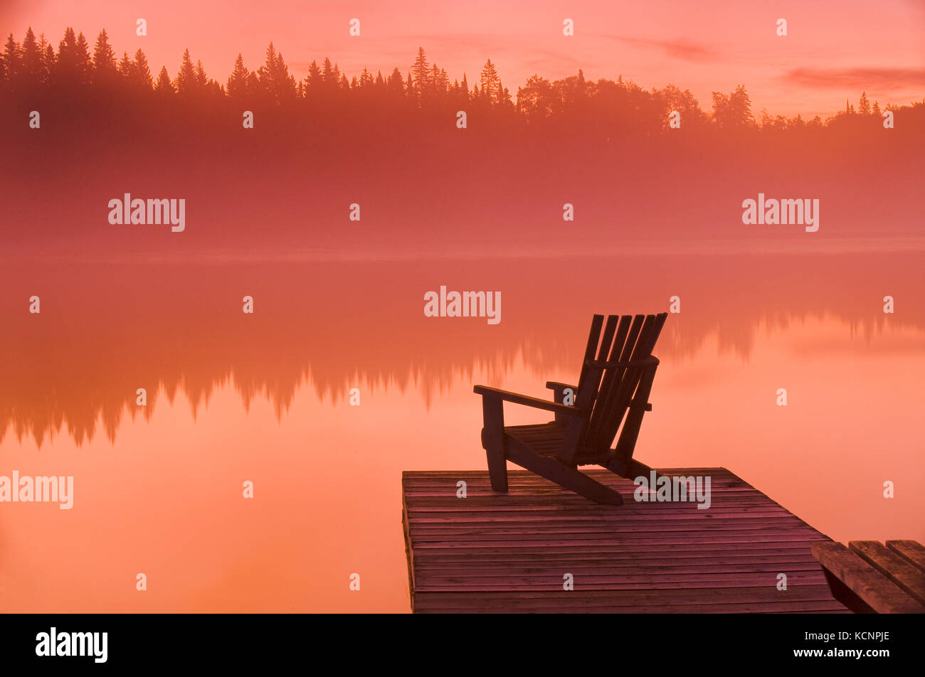 Muskoka chair on dock, Glad Lake, Duck Mountain Provincial Park, Manitoba, Canada Stock Photo