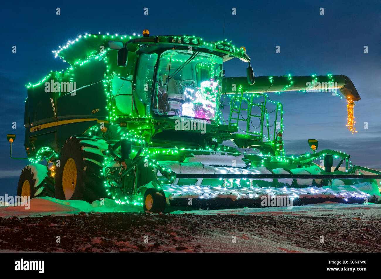 combine harvester with Christmas lights, Manitoba, Canada Stock Photo
