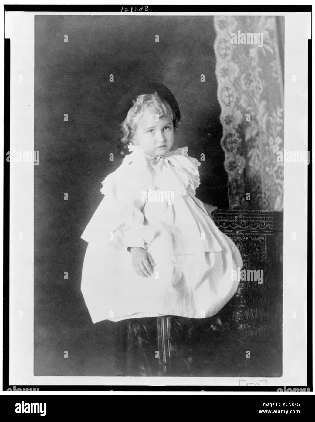African American girl, full length portrait, seated on stool, facing ...